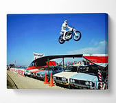 WALL ART MONSTER Knievel Car Jump Canvas Print Wall Art - Small 14 x 20 Inches, Multi-Colour